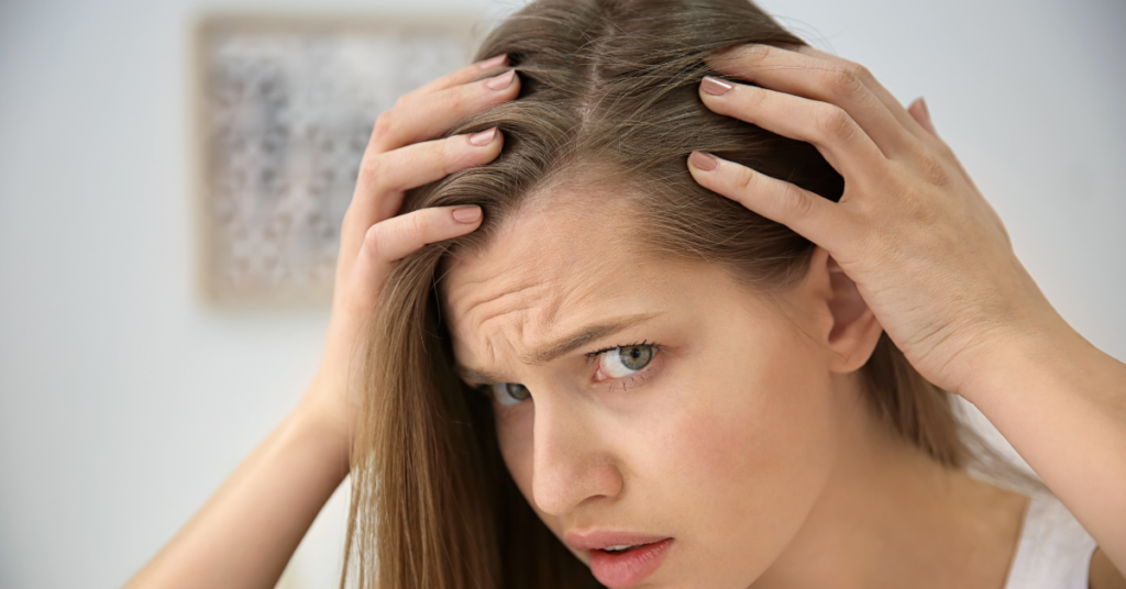 balding women looking in mirror